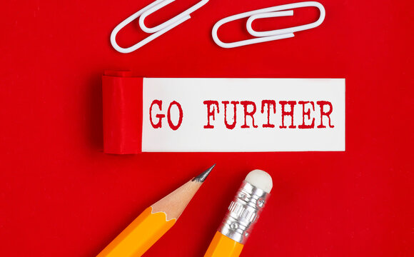 GO FURTHER message written under torn red paper with pencils and clips, business