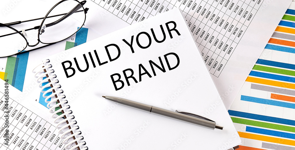 Poster notebook with text build your brand . diagram and white background,business concept