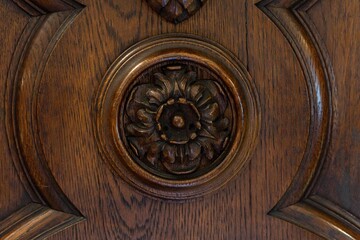 Fototapeta na wymiar beautiful vintage carved wooden ornament, antique round element on the ceiling