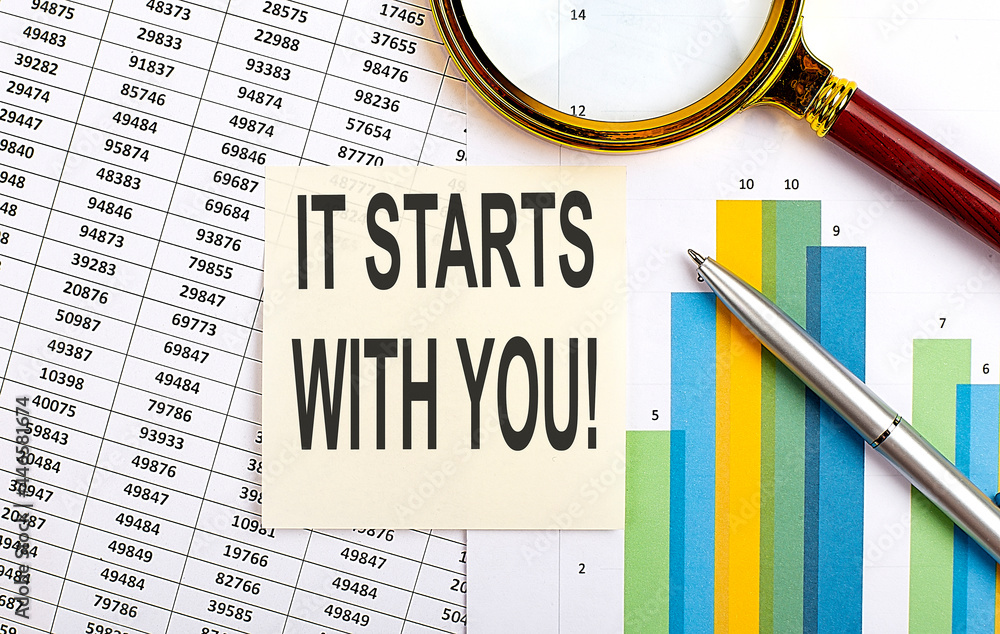 Poster business concept. top view of stiscker with text it starts with you on chart background