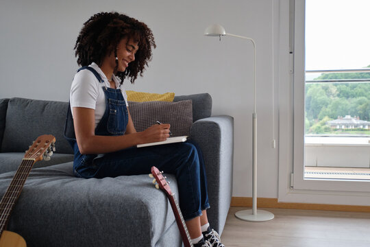 Black musician composing music at home