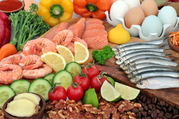 Pescatarian healthy food concept for an immune system boosting balanced diet high in protein and omega 3 with a collection of vegetables and fruit. Foods to help lower cholesterol and blood pressure.