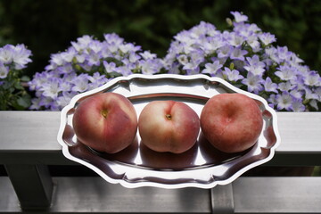 The flat peach (Prunus persica var. platycarpa), also known as the doughnut peach or Saturn peach,...