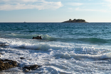 Waves trashng sharp rocky shore of Rogoznica, small tourist destination in central Dalmatia, Croatia