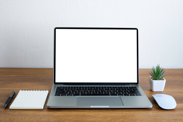 Fototapeta premium Front view of open laptop computer notebook with blank monitor white screen display on work table desk. Workspace office modern for job business online communication technology in shop or home indoor.