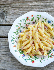  Italian home made   penne pasta  with  tuna  fish, parmesan cheese and black pepper .