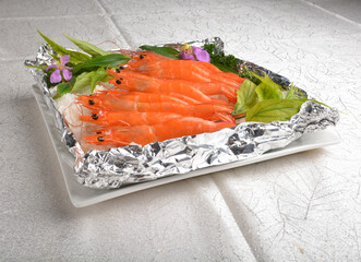 flaming bbq grilled big fresh tiger prawn seafood with salt ice on bottom asian halal menu