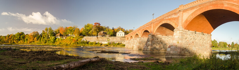 Long brick bridge in sunny autumn day, Kuldiga, Latvia.