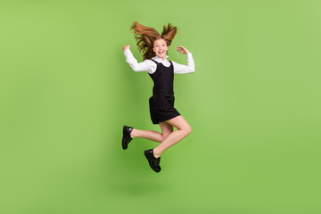 Full length body size view of attractive cheerful girl jumping having fun good mood isolated over green color background