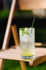 Alcoholic and non-alcoholic summer drinks with ice cubes of lemon, lime, fruits and mint. Summer holiday tropical concept.