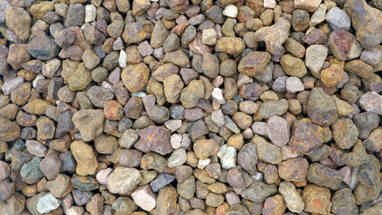 Granite gravel of macadam, Rock brown crushed for construction on the ground, Scree texture background