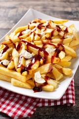 Traditional Canadian Poutine on wooden table