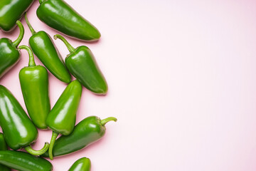 Jalapeno peppers, on a pink background, place for text. Top view.