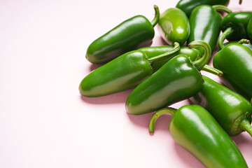 Jalapeno peppers, on a pink background, place for text.