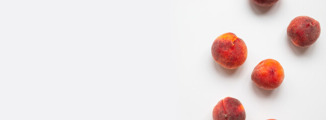 Fresh ripe peaches lie on a table with copyspace