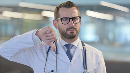 Portrait of Thumbs Down Gesture by Young Male Doctor