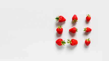 Fresh tasty strawberry with leaves on white background. Top view. Flat lay.
