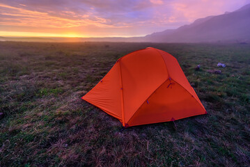 A camping tent on a colourful morning at the Centenery Hut in Drakensberg mountains.