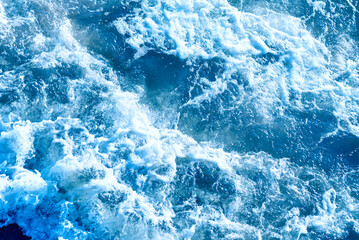 Fototapeta na wymiar Deep blue and rough sea with lot of sea spray.Blue background.Soft focus,blurred image.