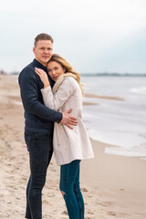 Obraz premium Two Young couple standing enjoying on a coast and enjoying each other.Summer,spring,autumn vacation.