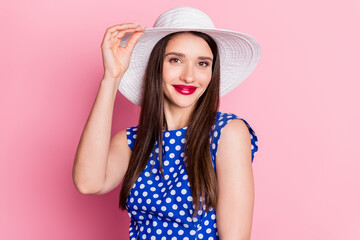 Photo of young attractive woman happy positive smile hand touch sunhat vacation isolated over pastel color background