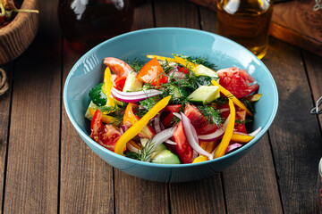 Fresh garden vegetables salad mix on a wooden background