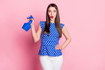 Photo of young woman amazed shocked surprised hold sprayer plant water isolated over pastel color background