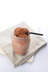 cold iced chocolate milo dinosaur with coco powder in glass jar white background asian beverage halal menu