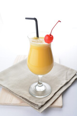 cold iced orange fruit juice with red cherry in cocktail glass white background asian beverage halal menu