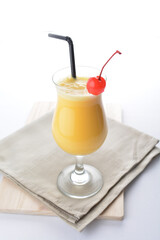 cold iced orange fruit juice with red cherry in cocktail glass white background asian beverage halal menu