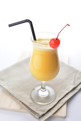 cold iced orange fruit juice with red cherry in cocktail glass white background asian beverage halal menu