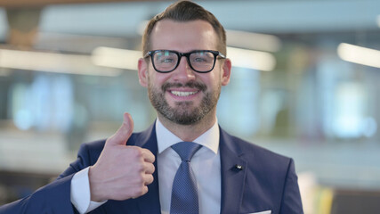 Fototapeta premium Middle Aged Businessman showing Thumbs Up Sign