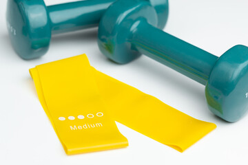 At home workout equipment – resistance bands and dumbbells.