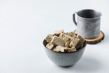 Halva slices in a bowl. Oriental sweetness. Copy space.