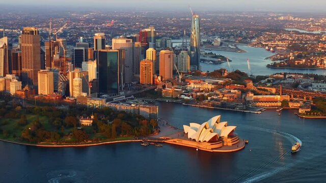 Bird's Eye View Of Sydney Opera House, Sydney Skyline, And Circular Quay At Sunset In NSW, Australia. - zoom out