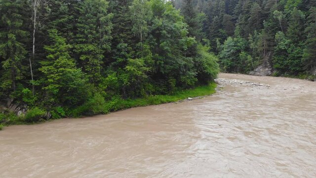 Mountain river after heavy rains. The water in the river is dirty from soil and stones. This situation is the forerunner of flooding in Europe.