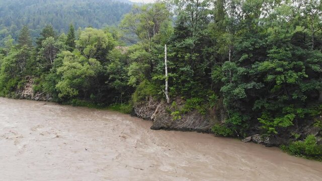 Mountain river after heavy rains. The water in the river is dirty from soil and stones. This situation is the forerunner of flooding in Europe.