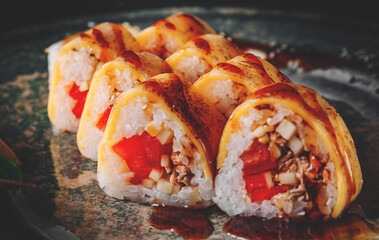 sushi roll in plate on black wooden table background
