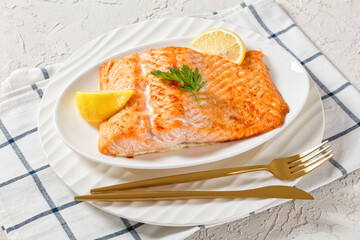 grilled salmon fillet on a white platter