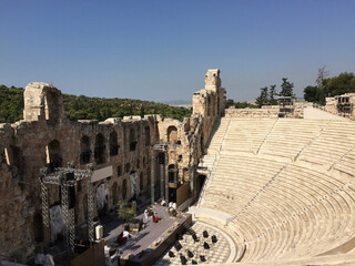 The Odeon of Herodes Atticus, also called Herodeion or Herodion, is a stone Roman theater structure located on the Acropolis of Athens. The Philopappos Monument on Hill of the Muses in the background 