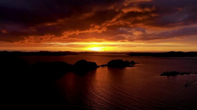 Dramatic Sunset Sky With Clouds At Poroporo Island In Bay Of Islands, New Zealand - aerial drone shot