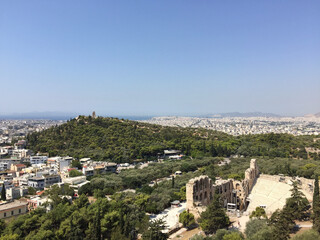 Fototapeta na wymiar View of the Philopappos Monument on Mouseion Hill (Hill of the Muses) and the Odeon of Herodes Atticus seen from the Athenian Acropolis in Athens, Greece.