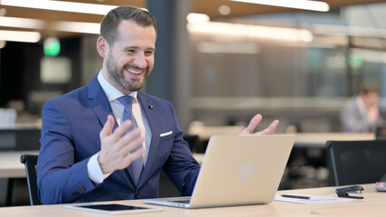 Fototapeta premium Successful Middle Aged Businessman Celebrating on Laptop at Work