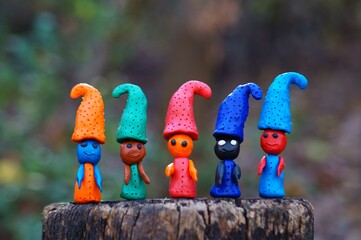 Figures of multi-colored gnomes on a colored background.