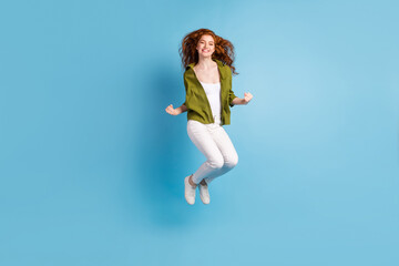 Fototapeta na wymiar Full length body size view of attractive lucky cheerful girl jumping rejoicing isolated over pastel blue color background