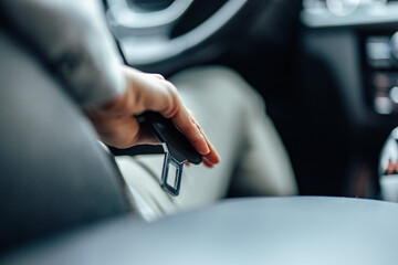 Seat belt about to be used, during a car drive.
