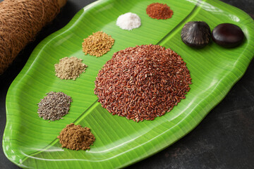 Ayurvedic porridge  Karkidaka Kanji herbal gruel  ingredients banana leaf background Kerala South India. Ayurveda diet health drink immunity, cleanse body. Top view medicinal porridge Indian veg food