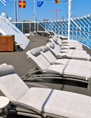 Patio or balcony on outdoor sun deck of luxury cruiseship cruise ship liner with deck chairs, sun...