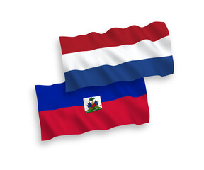 National vector fabric wave flags of Republic of Haiti and Netherlands isolated on white background. 1 to 2 proportion.