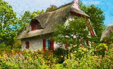 Painted traditional reed roof covered house with cottage garden on island Ruegen